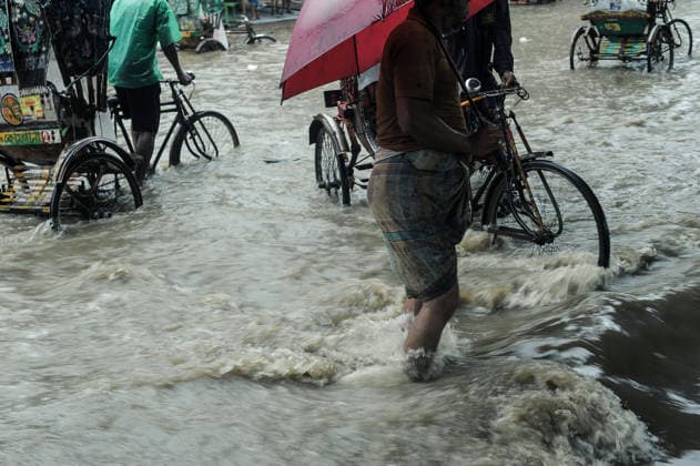 July 7, 2026: Chattogram, Bangladesh - Pedestrians, rickshaw pullers navigate a waterlogged street in the Bahaddarhat area of Chattogram on Tuesday, continuing three consecutive days of heavy rainfall. The persistent downpours triggered severe waterlogging across several parts of the port city, submerging roads, disrupting traffic, and causing widespread inconvenience to residents. - ZUMAr143 20260707_zap_r143_001 Copyright: xMdxRafayatxHaquexKhanx