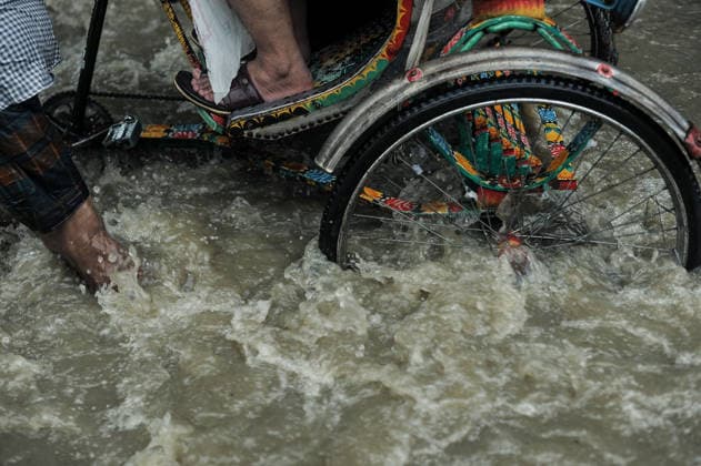 July 7, 2026: Chattogram, Bangladesh - A Rickshaw pullers navigate a waterlogged street in the Bahaddarhat area of Chattogram on Tuesday, continuing three consecutive days of heavy rainfall. The persistent downpours triggered severe waterlogging across several parts of the port city, submerging roads, disrupting traffic, and causing widespread inconvenience to residents. - ZUMAr143 20260707_zap_r143_003 Copyright: xMdxRafayatxHaquexKhanx