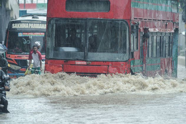 July 7, 2026: Chattogram, Bangladesh - A commuter bus navigate a waterlogged street in the Bahaddarhat area of Chattogram on Tuesday, continuing three consecutive days of heavy rainfall. The persistent downpours triggered severe waterlogging across several parts of the port city, submerging roads, disrupting traffic, and causing widespread inconvenience to residents. - ZUMAr143 20260707_zap_r143_009 Copyright: xMdxRafayatxHaquexKhanx