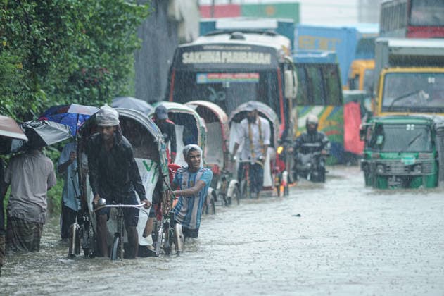 July 7, 2026: Chattogram, Bangladesh - Pedestrians, rickshaw pullers, and commuters navigate a waterlogged street in the Bahaddarhat area of Chattogram on Tuesday, continuing three consecutive days of heavy rainfall. The persistent downpours triggered severe waterlogging across several parts of the port city, submerging roads, disrupting traffic, and causing widespread inconvenience to residents. - ZUMAr143 20260707_zap_r143_008 Copyright: xMdxRafayatxHaquexKhanx