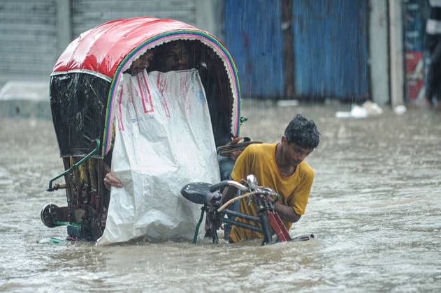 July 7, 2026: Chattogram, Bangladesh - A Rickshaw pullers navigate a waterlogged street in the Bahaddarhat area of Chattogram on Tuesday, continuing three consecutive days of heavy rainfall. The persistent downpours triggered severe waterlogging across several parts of the port city, submerging roads, disrupting traffic, and causing widespread inconvenience to residents. - ZUMAr143 20260707_zap_r143_011 Copyright: xMdxRafayatxHaquexKhanx