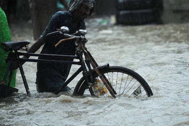 July 7, 2026: Chattogram, Bangladesh - A Rickshaw pullers navigate a waterlogged street in the Bahaddarhat area of Chattogram on Tuesday, continuing three consecutive days of heavy rainfall. The persistent downpours triggered severe waterlogging across several parts of the port city, submerging roads, disrupting traffic, and causing widespread inconvenience to residents. - ZUMAr143 20260707_zap_r143_014 Copyright: xMdxRafayatxHaquexKhanx