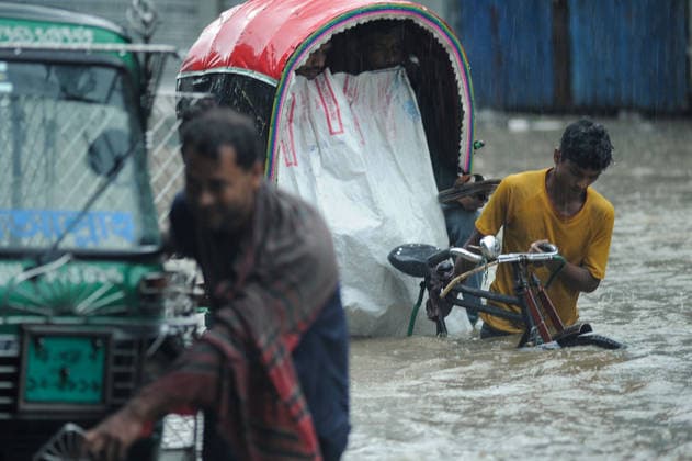 July 7, 2026: Chattogram, Bangladesh - Pedestrians, rickshaw pullers, navigate a waterlogged street in the Bahaddarhat area of Chattogram on Tuesday, continuing three consecutive days of heavy rainfall. The persistent downpours triggered severe waterlogging across several parts of the port city, submerging roads, disrupting traffic, and causing widespread inconvenience to residents. - ZUMAr143 20260707_zap_r143_020 Copyright: xMdxRafayatxHaquexKhanx