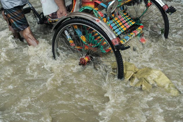 July 7, 2026: Chattogram, Bangladesh - A Rickshaw pullers navigate a waterlogged street in the Bahaddarhat area of Chattogram on Tuesday, continuing three consecutive days of heavy rainfall. The persistent downpours triggered severe waterlogging across several parts of the port city, submerging roads, disrupting traffic, and causing widespread inconvenience to residents. - ZUMAr143 20260707_zap_r143_023 Copyright: xMdxRafayatxHaquexKhanx