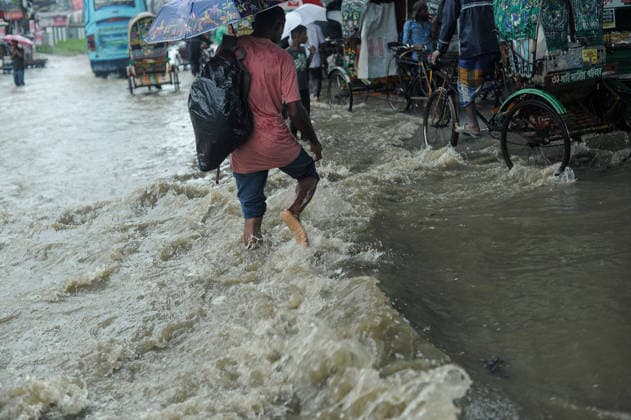 July 7, 2026: Chattogram, Bangladesh - Pedestrian navigate a waterlogged street in the Bahaddarhat area of Chattogram on Tuesday, continuing three consecutive days of heavy rainfall. The persistent downpours triggered severe waterlogging across several parts of the port city, submerging roads, disrupting traffic, and causing widespread inconvenience to residents. - ZUMAr143 20260707_zap_r143_026 Copyright: xMdxRafayatxHaquexKhanx