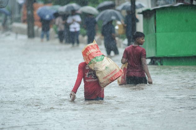July 7, 2026: Chattogram, Bangladesh - Pedestrian navigate a waterlogged street in the Bahaddarhat area of Chattogram on Tuesday, continuing three consecutive days of heavy rainfall. The persistent downpours triggered severe waterlogging across several parts of the port city, submerging roads, disrupting traffic, and causing widespread inconvenience to residents. - ZUMAr143 20260707_zap_r143_030 Copyright: xMdxRafayatxHaquexKhanx