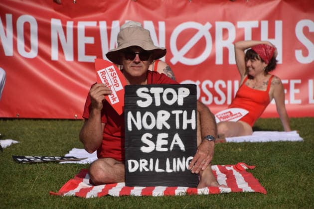July 7, 2026, London, England, United Kingdom: Climate activists from the group Fossil Free London don swimming costumes and stage a Ã¢â‚¬Ëœsunbathe-inÃ¢â‚¬â ¢ protest dubbed Roast Against Rosebank in Parliament Square calling on the government to stop new North Sea oil and gas projects, as another heatwave hits the UK. London United Kingdom  - ZUMAv130 20260707_zip_v130_030 Copyright: xVukxValcicx
