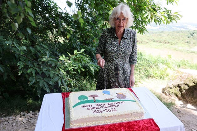 Queen Camilla Commemorates 100 Years Of Winnie The Pooh HARTFIELD, ENGLAND - JULY 07: Queen Camilla cuts a cake during her visit to Ashdown Forest to commemorate 100 Years of Winnie-the-Pooh at Ashdown Forest on July 07, 2026 in Hartfield, England. Ashdown Forest was the inspiration for the Hundred Acre Wood in A.A. Milne s classic Winnie-the-Pooh children s books. The Queen visited the forest in her role as patron of the Royal Literary Fund., Credit:Chris Jackson PA ROTA - B68 Avalon United Kingdom, England, Hartfield, Ashdown Forest  Copyright: xChrisxJacksonx xPAxROTAx-xB68x xAvalonx 1115013615