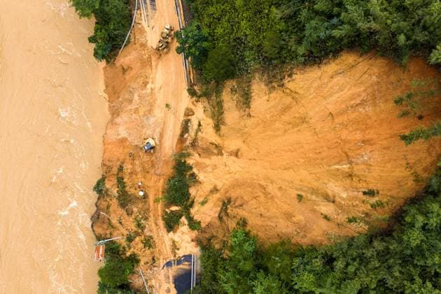 (260707) -- LAIBIN, July 7, 2026 -- An aerial drone photo taken on July 7, 2026 shows emergency restoration of a damaged highway in Qingshan Village of Jinxiu Yao Autonomous County, Laibin City, south China s Guangxi Zhuang Autonomous Region. Recent extreme rainstorms triggered by Typhoon Maysak, the 10th typhoon of the year, have caused severe flooding in parts of south China s Guangxi Zhuang Autonomous Region. Traffic of several national and provincial highways in Jinxiu Yao Autonomous County has been disrupted. Emergency restoration of the damaged roads is underway. (Photo by Xinhua) (SpotNews) CHINA-GUANGXI-LAIBIN-TYPHOON-DAMAGED ROADS (CN) GaoxRujin 