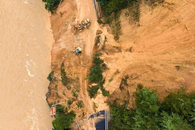 (260707) -- LAIBIN, July 7, 2026 -- An aerial drone photo taken on July 7, 2026 shows emergency restoration of a damaged highway in Qingshan Village of Jinxiu Yao Autonomous County, Laibin City, south China s Guangxi Zhuang Autonomous Region. Recent extreme rainstorms triggered by Typhoon Maysak, the 10th typhoon of the year, have caused severe flooding in parts of south China s Guangxi Zhuang Autonomous Region. Traffic of several national and provincial highways in Jinxiu Yao Autonomous County has been disrupted. Emergency restoration of the damaged roads is underway. (Photo by Xinhua) (SpotNews) CHINA-GUANGXI-LAIBIN-TYPHOON-DAMAGED ROADS (CN) GaoxRujin 