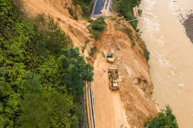 (260707) -- LAIBIN, July 7, 2026 -- An aerial drone photo taken on July 7, 2026 shows emergency restoration of a damaged highway in Qingshan Village of Jinxiu Yao Autonomous County, Laibin City, south China s Guangxi Zhuang Autonomous Region. Recent extreme rainstorms triggered by Typhoon Maysak, the 10th typhoon of the year, have caused severe flooding in parts of south China s Guangxi Zhuang Autonomous Region. Traffic of several national and provincial highways in Jinxiu Yao Autonomous County has been disrupted. Emergency restoration of the damaged roads is underway. (Photo by Xinhua) (SpotNews) CHINA-GUANGXI-LAIBIN-TYPHOON-DAMAGED ROADS (CN) GaoxRujin 