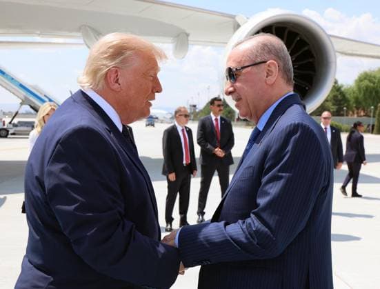 US President Donald Trump is greeted by Turkish President Recep Tayyip Erdogan, left, upon arriving for the NATO summit in Ankara, Turkey, Tuesday, July 7, 2026. (Turkish Presidency Pool - Depo Photos) 19155680