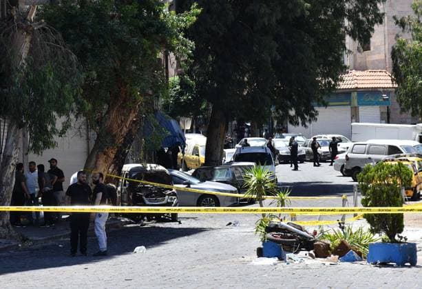 (260707) -- DAMASCUS, July 7, 2026 -- Security personnel cordon off the area around the blast site near the Ministry of Tourism building in central Damascus, Syria, July 7, 2026. Two explosions in central Damascus on Tuesday injured 18 people during a visit by French President Emmanuel Macron, according to Syria s Interior Ministry. (Photo by Xinhua) SYRIA-DAMASCUS-EXPLOSIONS AmmarxSafarjalani 