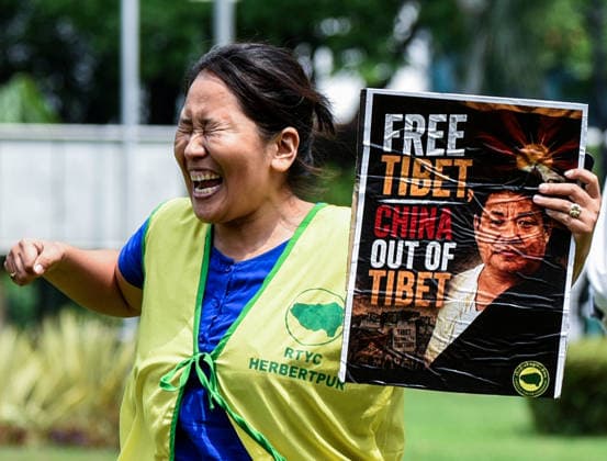 TYC Protests Near the Chinese Embassy in New Delhi New Delhi, Jul 07 (ANI): A Tibetan Youth Congress (TYC) supporter holds a poster and raises slogans during the party s protest over their various demands near the Chinese Embassy, in New Delhi on Tuesday. NEW DELHI Delhi India Copyright: xANIx ANI_20260707063