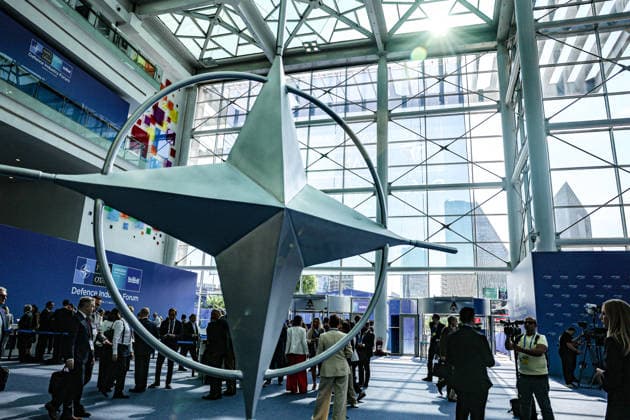 July 7, 2026, Ankara, Turkiye, Turkiye: Delegates and media personnel gather around a massive rotating steel NATO compass rose emblem in the main atrium of the ATO Congresium during the NATO Summit Defence Industry Forum (NSDIF). The flagship forum brought together alliance leaders, defence ministers, and global aerospace executives to finalize more than 70 billion USD in joint procurement contracts aimed at streamlining transatlantic weapons manufacturing and production scaling Ankara Turkiye  - ZUMAo116 20260707_znp_o116_037 Copyright: xBiancaxOterox