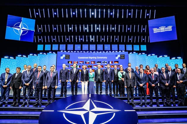 July 7, 2026, Ankara, Turkiye, Turkiye: NATO Deputy Secretary General RADMILA SEKERINSKA (C in black jacket), President of the Turkish Secretariat of Defence Industries HALUK GORGUN (CR in black jacket), Roketsan stand on stage for a family photo alongside international defence ministers, foreign affairs delegates, and corporate executives during the Combined Signing Ceremony at the NATO Summit Defence Industry Forum (NSDIF) at the ATO Congresium. The wide group assembly, set against a digital background displaying allied national flags, marked the finalisation of a monumental multi-billion dollar transatlantic investment package coordinating multi-layered air defence shields, precision munitions, and strategic space surveillance infrastruc - ZUMAo116 20260707_znp_o116_045 Copyright: xBiancaxOterox