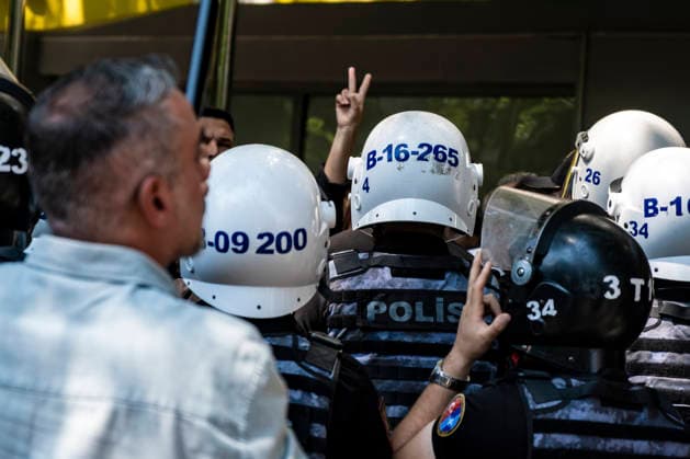 Anti NATO Demonstration Ankara Turkey July 7 A demonstrator makes a peace sign behind a line of police officers during an anti-NATO protest in Ankara, Turkey, on July 7, 2026. Ankara is hosting the NATO Summit on July 7-8, bringing together heads of state and government from numerous member countries. As security measures were intensified across the capital, police dispersed the demonstration, detained numerous protesters, and restricted access for journalists. Ankara Ankara Turkey Copyright: xMuratxKocabasx