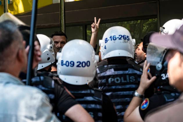 Anti NATO Demonstration Ankara Turkey July 7 A demonstrator makes a peace sign behind a line of police officers during an anti-NATO protest in Ankara, Turkey, on July 7, 2026. Ankara is hosting the NATO Summit on July 7-8, bringing together heads of state and government from numerous member countries. As security measures were intensified across the capital, police dispersed the demonstration, detained numerous protesters, and restricted access for journalists. Ankara Ankara Turkey Copyright: xMuratxKocabasx