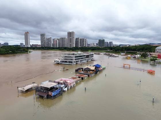 NANNING, CHINA - JULY 07: Floodwaters submerge riverside walkways and shops on July 7, 2026 in Nanning, Guangxi Zhuang Autonomous Region of China. Recent extreme rainstorms triggered by Typhoon Maysak, the 10th typhoon of the year, have caused severe flooding in parts of south China s Guangxi Zhuang Autonomous Region.  Copyright: xVCGx 111652813939