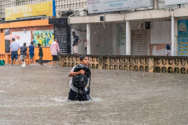 Bangladesh: Severe Waterlogging Paralyzes Chattogram Amid Heavy Monsoon Rain In Chattogram A schoolboy carries his backpack close to his chest as he wades through knee-deep water on an inundated road in Chattogram, Bangladesh, on July 7, 2026. Educational institutions and daily businesses face low attendance due to the severe waterlogging. Chattogram Bangladesh  Copyright: xZakirxHossainx originalFilename: hossain-notitle260707_npYgL.jpg