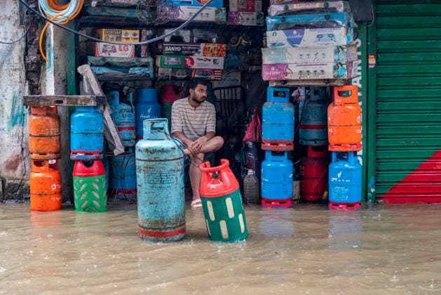 Bangladesh: Severe Waterlogging Paralyzes Chattogram Amid Heavy Monsoon Rain In Chattogram A shopkeeper sits amidst stacks of LPG gas cylinders inside his partially flooded store during heavy monsoon rain in Chattogram, Bangladesh, on July 7, 2026. Continuous torrential downpours have caused widespread urban waterlogging, submerging markets and disrupting retail businesses across the port city. Chattogram Bangladesh  Copyright: xZakirxHossainx originalFilename: hossain-notitle260707_npxAz.jpg