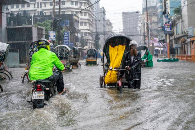 Bangladesh: Severe Waterlogging Paralyzes Chattogram Amid Heavy Monsoon Rain In Chattogram A motorcyclist splashes through a deeply flooded street alongside a rickshaw puller in Chattogram, Bangladesh, on July 7, 2026. The active monsoon season has caused water levels to rise rapidly across key residential and commercial zones. Chattogram Bangladesh  Copyright: xZakirxHossainx originalFilename: hossain-notitle260707_npGkm.jpg
