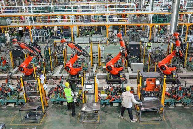 JINHUA, CHINA - JULY 07: Industrial robots operate at full speed while workers produce new energy vehicle parts to fulfill orders at the workshop of Jinhua Zhixin Technology Co., Ltd. on July 7, 2026 in Jinhua, Zhejiang Province of China.  Copyright: xVCGx 111652834352
