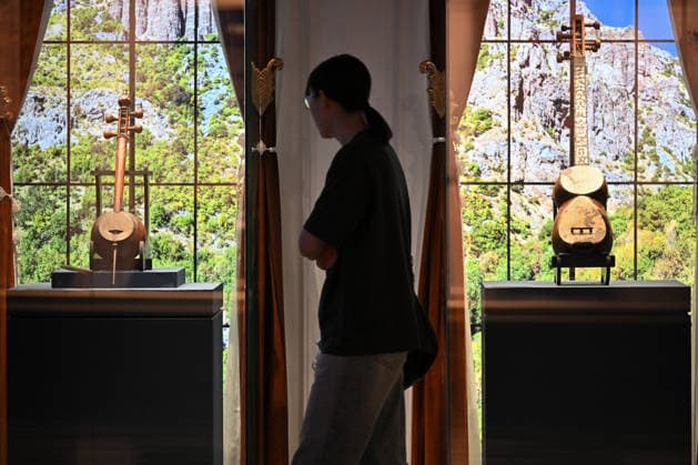 TAIYUAN, CHINA - JULY 08: Visitors view a tar (left) and a kamancha, Armenian musical instruments from the 20th century, at an exhibition on July 8, 2026 in Taiyuan, Shanxi Province of China. The exhibition, titled Land of Noah, features 134 sets of precious artifacts from the Yerevan History Museum in Armenia, marking their first large-scale display in Shanxi. The collection includes traditional costumes, silverware, musical instruments, carpets, embroidery, oil paintings, and pottery.  Copyright: xChinaxNewsxServicex 111653054046