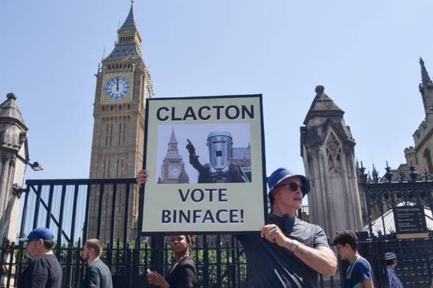 Protesters hold anti-Farage placards as the Reform leader resigns as MP for Clacton, London, UK - 8 Jul 2026 An activist holds a placard urging Clacton to vote for the satirical candidate Count Binface during the weekly anti-Brexit and pro-EU protest in Parliament Square. Nigel Farage has resigned as MP for Clacton triggering a by-election. London United Kingdom Copyright: xVukxValcicx xSOPAxImagesx VukValcicFarageProtest080726_16