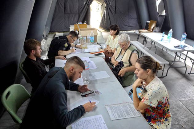 RECORD DATE NOT STATED Police officers receive property damage reports at a tent of the State Emergency Service of Ukraine during recovery operations following a combined Russian attack and secondary explosions of explosive ordnance, Vyshneve, Kyiv region, Ukraine, on July 7, 2026. During the night of July 6, Russian forces launched a massive attack on Kyiv and the surrounding region using various types of missiles and attack drones. According to the State Emergency Service of Ukraine, seven people were killed in Vyshneve. Residential development on five streets was completely destroyed, while warehouses and businesses sustained damage. More than 600 local residents were evacuated because of the risk posed by unexploded ordnance (Photo by Volodymyr Tarasov Ukrinf  Copyright: xVolodymyrxTarasovx