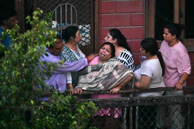 NEW DELHI, INDIA - JULY 8: Family members mourn outside the site where a building collapsed in G Block, Sector 16, Rohini on July 8, 2026 in New Delhi, India. Rescue operations by the NDRF and other emergency agencies continued as authorities searched the debris for survivors and assessed the cause of the collapse. (Photo by Sanchit Khanna Hindustan Times) Man Killed As Under-Construction Building Collapses In Delhi s Rohini Sector 16