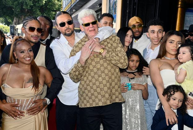 Bizzy Bone of the Hip-Hop group Bone Thugs-N-Harmony hugs his father Robert Cass Floyd during a ceremony honoring them with the 2,851st star on the Hollywood Walk of Fame in Los Angeles on Wednesday, July 8, 2026. At left is Layzie Bone and his wife Felecia Lindsey-Howse.  LAP2026070819 JIMxRUYMEN