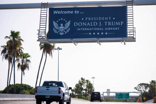 July 8, 2026, West Palm Beach, Fl, USA: Cars travel toward the airport entrance beneath a new Ã¢â‚¬oePresident Donald J. Trump International AirportÃ¢â‚¬Â sign, with a nearby directional board listing. West Palm Beach USA  - ZUMAc343 20260708_znp_c343_003 Copyright: xChrisxBeckettx