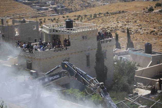 Israeli forces demolish home in southern West Bank town of Yatta Israeli forces demolish the two-story home of Palestinian resident Iyad Musleh al-Amour in the Khallet al-Miyeh area, east of the town of Yatta, south of Hebron in the occupied West Bank, on July 9, 2026. The house was home to three families comprising 15 people. According to local residents, the demolition was carried out on the grounds that the building lacked a permit, leaving the families displaced. Photo by Mamoun Wazwaz apaimages Hebron West Bank Palestinian Territory 090726_Hebron_MW_00(40) Copyright: xapaimagesxMamounxWazwazx xapaimagesx