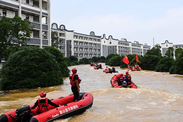 (260709) -- NANNING, July 9, 2026 -- Rescuers take rubber boats to evacuate trapped students in Guigang City, south China s Guangxi Zhuang Autonomous Region, July 9, 2026. Recent extreme rainstorms triggered by Typhoon Maysak, the 10th typhoon of the year, have caused severe flooding in parts of Guangxi in the Pearl River basin. Guangxi is continuing its search and rescue operations for missing persons, enhancing resettlement services for affected residents and advancing post-disaster reconstruction. ) FOCUS Guangxi makes all-out rescue, relief efforts after rain-triggered disasters CaoxYiming 