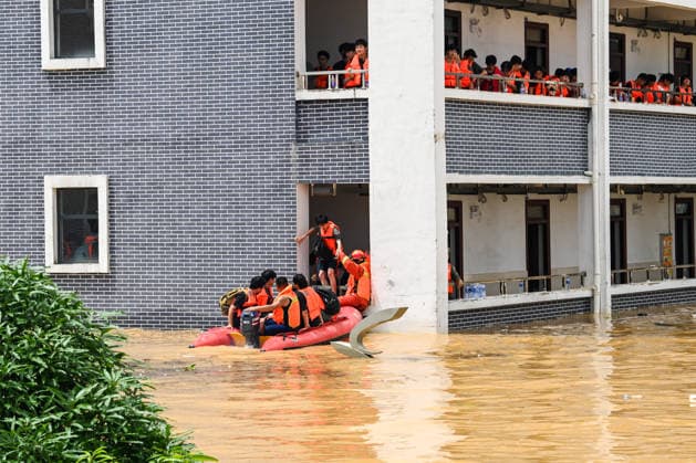 (260709) -- NANNING, July 9, 2026 -- Rescuers evacuate trapped students in Guigang City, south China s Guangxi Zhuang Autonomous Region, July 9, 2026. Recent extreme rainstorms triggered by Typhoon Maysak, the 10th typhoon of the year, have caused severe flooding in parts of Guangxi in the Pearl River basin. Guangxi is continuing its search and rescue operations for missing persons, enhancing resettlement services for affected residents and advancing post-disaster reconstruction. ) FOCUS Guangxi makes all-out rescue, relief efforts after rain-triggered disasters CaoxYiming 