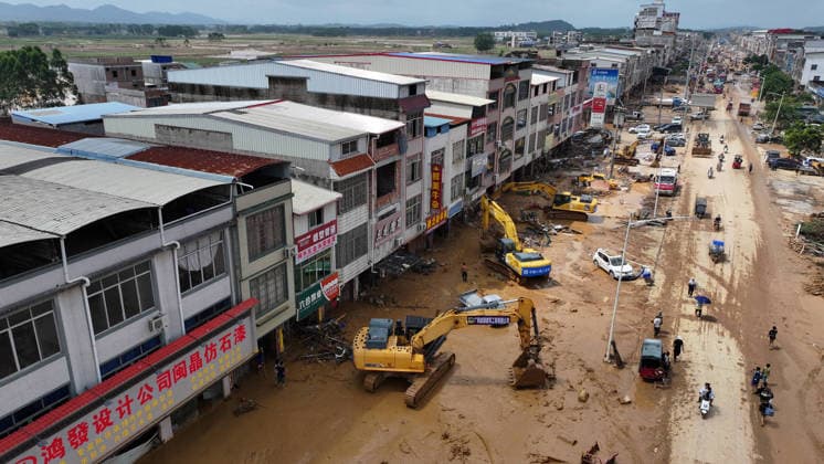 (260709) -- NANNING, July 9, 2026 -- A drone photo shows people removing silt and debris from a street after floodwater recedes in Yunbiao Town of Hengzhou City, south China s Guangxi Zhuang Autonomous Region, July 9, 2026. Recent extreme rainstorms triggered by Typhoon Maysak, the 10th typhoon of the year, have caused severe flooding in parts of Guangxi in the Pearl River basin. Guangxi is continuing its search and rescue operations for missing persons, enhancing resettlement services for affected residents and advancing post-disaster reconstruction. ) FOCUS Guangxi makes all-out rescue, relief efforts after rain-triggered disasters HuangxXiaobang 
