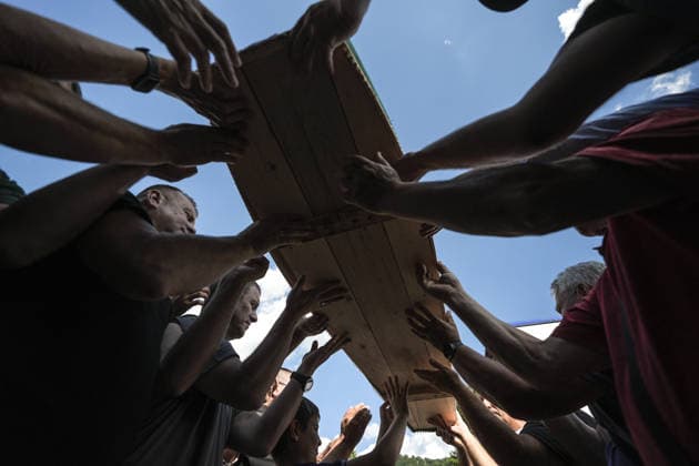 Column with the coffins of ten victims of the Srebrenica genocide has arrived in Potocari POTOCARI, BOSNIA AND HERZEGOVINA - JULY 09: People carry coffins containing the remains of victims of the 1995 Srebrenica genocide upon their arrival at the Memorial Center as family members and friends gather at the former Battery Factory to pay their respects to those who will be laid to rest during a collective funeral on July 11 in Potocari, Bosnia and Herzegovina, on July 09, 2026. Samir Jordamovic Anadolu Potocari Bosnia and Herzegovina. Editorial use only. Please get in touch for any other usage.  Copyright: x2026xAnadoluxSamirxJordamovicx