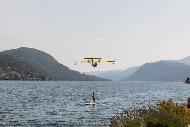 Wildfires rage for 10th day in northern Italy ORTA, ITALY - JULY 9: A firefighting Canadair aircraft scoops up a load of water from Lake Orta to combat a wildfire devastating the mountains of Piedmont, Italy on July 9, 2026. The blaze has been raging for ten days, with hundreds of hectares of land going up in smoke in the last 24 hours alone. Despite continuous aerial operations, the fire remains out of control, fueled by strong winds, prolonged lack of rainfall, and recent extremely high temperatures. Andrea Carrubba Anadolu Piedmont Italy. Editorial use only. Please get in touch for any other usage.  Copyright: x2026xAnadoluxAndreaxCarrubbax