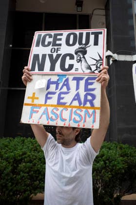 July 9, 2026, New York, New York, USA: A protester holds a sign that reads ICE OUT OF NYC with an image of the Statue of Liberty HATE plus FEAR equals FASCISM at Rise and Resist s weekly vigil for those impacted by President Trump s immigrant detention and mass deportation policies, held outside the immigration courts, Department of Homeland Security and ICE offices at 26 Federal Plaza in Lower Manhattan. The demonstration takes place days after the death of L. Salgado Araujo who was shot and killed by U.S. Immigration and Customs Enforcement (ICE) in Houston during a targeted enforcement operation. New York USA  - ZUMAr174 20260709_znp_r174_004 Copyright: xGinaxMxRandazzox