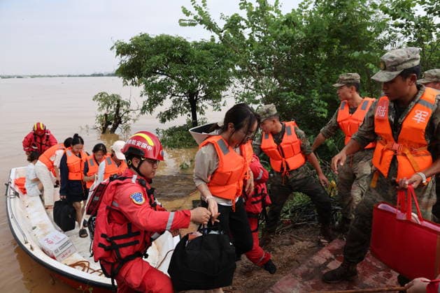 GUIGANG, CHINA - JULY 09: Rescuers evacuate trapped students on July 9, 2026 in Guigang, Guangxi Zhuang Autonomous Region of China. Recent extreme rainstorms triggered by Typhoon Maysak, the 10th typhoon of the year, have caused severe flooding in parts of Guangxi in the Pearl River basin. Guangxi is continuing its search and rescue operations for missing persons, enhancing resettlement services for affected residents and advancing post-disaster reconstruction.  Copyright: xVCGx 111653352911