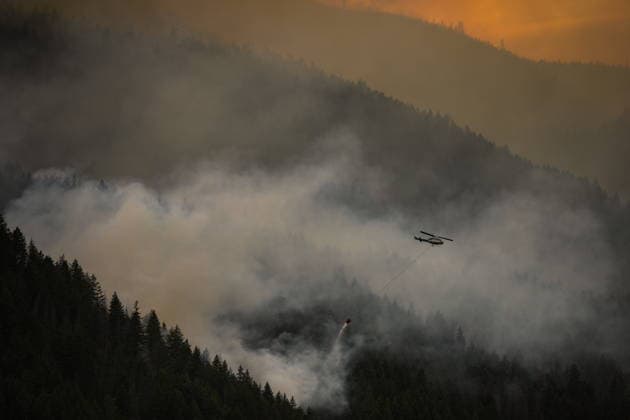 July 9, 2026, Boston Bar, Bc, CANADA: A helicopter turns to pick up more water while fighting the Brunswick Creek wildfire in Boston Bar, B.C., on Thursday, July 9, 2026. Boston Bar CANADA  - ZUMAc35_ 20260709_zaf_c35_077 Copyright: xDarrylxDyckx