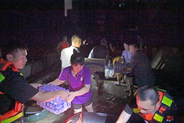 (260710) -- GUIGANG, July 10, 2026 -- Rescuers deliver supplies to stranded residents in Guigang, south China s Guangxi Zhuang Autonomous Region, July 9, 2026. Guigang has suffered severe flooding due to torrential rains brought by Typhoon Maysak and upstream inflows. Local authorities have mobilized rescue forces to work around the clock, making every effort to ensure basic living needs for stranded residents. ) CHINA-GUANGXI-GUIGANG-TYPHOON-FLOOD-RESCUE (CN) ZhouxHua 