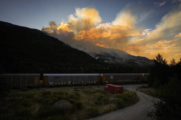 July 9, 2026, Boston Bar, Bc, CANADA: A CPKC train passes the Brunswick Creek wildfire burning in the mountains, in Boston Bar, B.C., on Thursday, July 9, 2026. Boston Bar CANADA  - ZUMAc35_ 20260709_zaf_c35_095 Copyright: xDarrylxDyckx