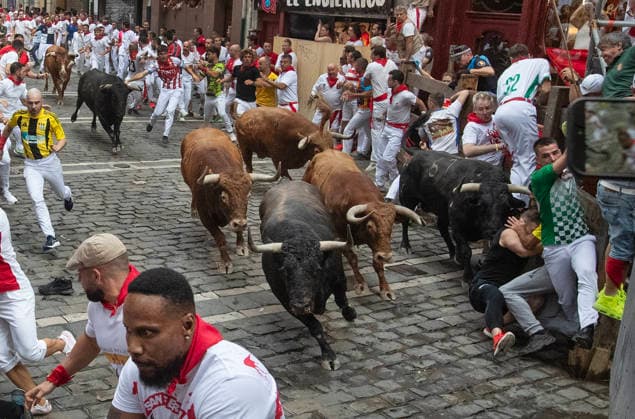 The fighting bulls from the ranch of Alvaro Nunez stampede through the Old City streets in the fourth running-of-the-bulls in Pamplona, northern Spain on Friday, July 20, 2026. Several runners were injured the morning but none were gored.  PAM20260710104 JimxHollander
