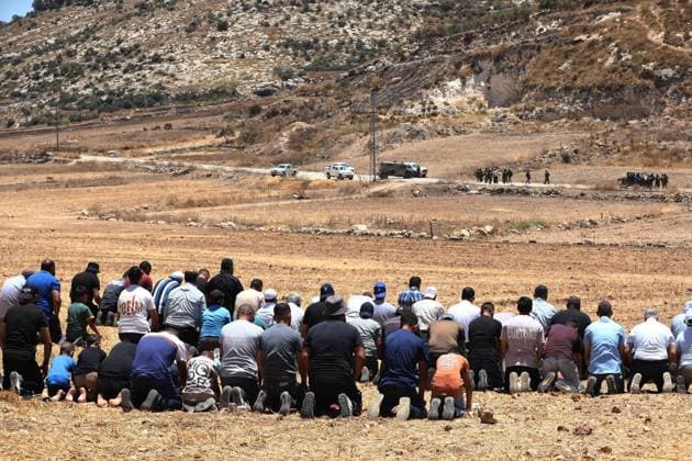 Israeli settlers prevented Palestinian farmers from accessing their agricultural lands in Hebron HEBRON, WEST BANK, PALESTINE - JULY 10: Palestinians perform Friday prayers on land threatened with confiscation by Israel while Israeli settlers, protected by Israeli forces, continue to block roads leading to Palestinian farmers lands in the town of Izna, near Hebron, West Bank, Palestine on July 10, 2026. Wisam Hashlamoun Anadolu Hebron West Bank. Editorial use only. Please get in touch for any other usage.  Copyright: x2026xAnadoluxWisamxHashlamounx
