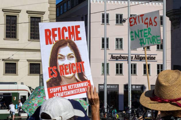 Augsburg, Bavaria, Germany - July 10, 2026: Demonstration by the climate justice movement Fridays for Future and Greenpeace in Augsburg. Under the nationwide slogan: Protect the climate, fire Reiche, the activists are protesting, among other things, against current gas infrastructure policy and planned gas drilling in Bavaria. A poster featuring a portrait of Katherina Reiche, Federal Minister for Economic Affairs and Energy of the Federal Republic of Germany, bears the inscription: REICHE, ENOUGH IS ENOUGH! STOP THE MINISTER OF NEPOTISM! *** Demonstration der Klimaschutzbewegung Fridays for Future und GREENPEACE in Augsburg. Unter dem bundesweiten Motto: Klima schützen, Reiche entlassen, protestieren die Aktivisten unter ande