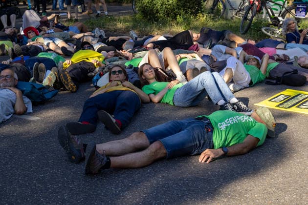 Augsburg, Bavaria, Germany July 10, 2026: Demonstration by the climate justice movement Fridays for Future and Greenpeace in Augsburg. Under the nationwide slogan Protect the climate, fire the rich, activists are protesting, among other things, against current gas infrastructure policies and planned gas drilling in Bavaria. Activists have lain down in the street to symbolize climate-related deaths caused by heat *** Demonstration der Klimaschutzbewegung Fridays for Future und GREENPEACE in Augsburg. Unter dem bundesweiten Motto: Klima schützen, Reiche entlassen, protestieren die Aktivisten unter anderem gegen die aktuelle Gas-Infrastrukturpolitik und geplante Gasbohrungen in Bayern. Aktivisten haben sich auf die Straße gelegt um