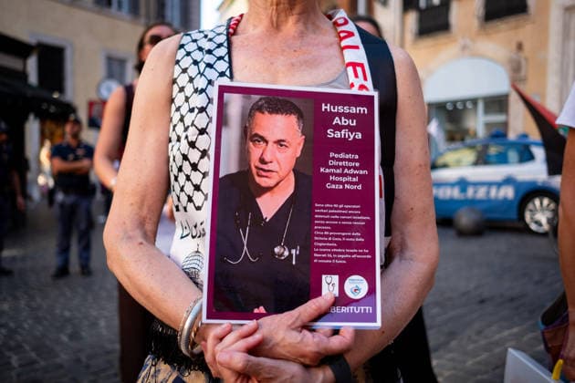 July 10, 2026, Rome, Rm, Italy: Activists from the group Health Workers for Gaza are holding a rally in front of Montecitorio, the Chamber of Deputies, to demand the release of Dr. Hussam Abu Safiya and all other Palestinian prisoners. A participant shows the picture of Dr. Abu Safiya. Rome Italy - ZUMAg256 20260710_znp_g256_007 Copyright: xMarcoxDixGianvitox