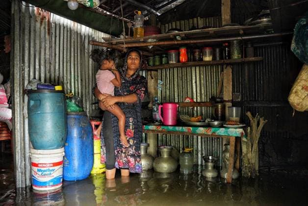 July 10, 2026, Banshkhali, Bangladesh: BANSHKHALI, CHATTOGRAM, BANGLADESH Ã¢â‚¬ JULY 10, 2026: Residents wade through floodwaters and evacuate children and belongings after days of heavy monsoon rainfall, runoff from surrounding hills and high tides caused severe flooding in Banshkhali Upazila, Chattogram. Hundreds of homes, roads and agricultural land have been inundated, leaving many families stranded and increasing concerns over access to shelter, clean water and essential services. Authorities and local volunteers continue to monitor the situation as affected residents wait for floodwaters to recede. Photos by JNA PRESS. Banshkhali Bangladesh  - ZUMAq101 20260710_zna_q101_062 Copyright: xIstiyakxAhamedxSrabonx